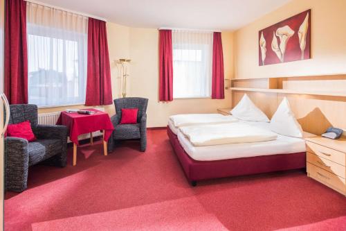 诺德奈巴科尔酒店的酒店客房带一张床、一张桌子和椅子
