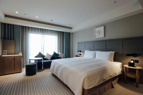 Greet Inn 喜迎旅店客房内的一张或多张床位