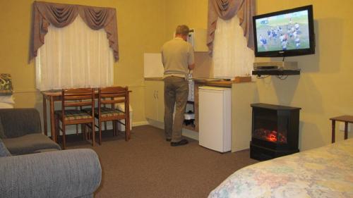 维多利亚山雪松山林小屋的一名在旅馆房间玩电子游戏的人