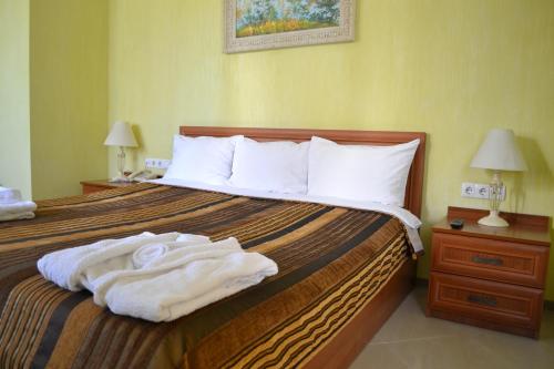 文尼察Hotel Strike的酒店客房,配有带毛巾的床