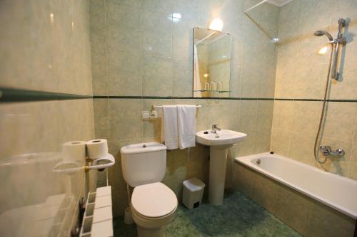拉阿贝尔卡Hostal San Blas的浴室配有卫生间、盥洗盆和浴缸。