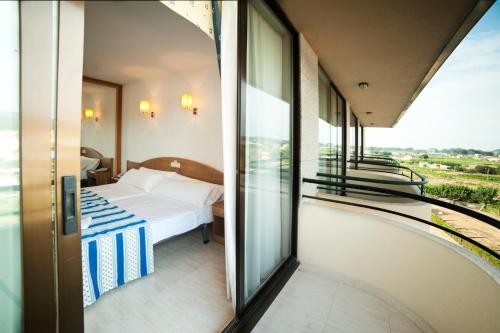 比利亚隆加利雅月酒店的酒店客房设有一张床和一个阳台。