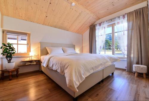 格伦Sonn Alpin - Ferienwohnungen的一间卧室设有一张大床和一个大窗户