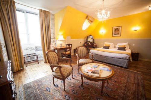 圣马洛科伦姆比城堡酒店的酒店客房带一张床、一张桌子和椅子