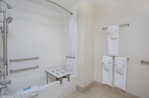 卡温顿科温顿智选假日酒店及套房的带淋浴和盥洗盆的白色浴室