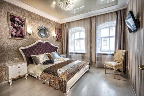 利沃夫2 - bedroom Apartments Galicia Lviv的一间卧室配有一张大床和一把椅子