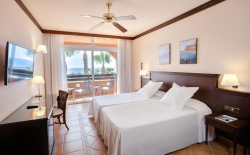 莫罗德哈布雷Occidental Jandía Playa的酒店客房设有一张床和一个阳台。