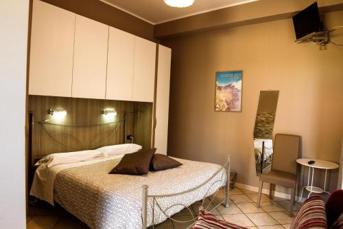 尼科洛西火山腹地住宿加早餐酒店的一间卧室配有一张床、一个橱柜和一把椅子