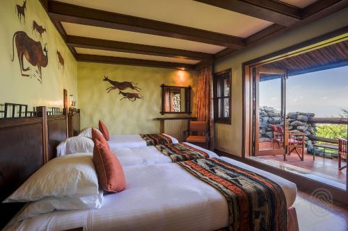 恩戈罗恩戈罗恩戈罗恩戈罗塞雷纳狩猎旅馆 的一间带大床的卧室和一个阳台