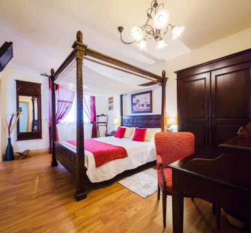 奥维罗A Feira Posada的一间卧室配有一张天蓬床和一张书桌
