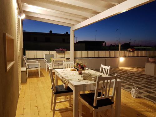 滨海波利尼亚诺Pietra di Luna的屋顶庭院配有白色的桌椅