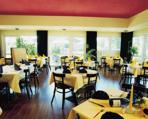 因戈尔施塔特Ara Classic的餐厅设有桌椅和黄色桌布