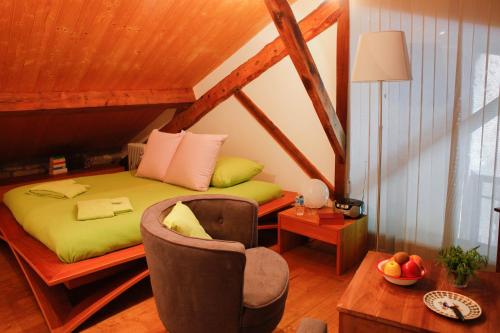Puivert岩间磨坊旅馆的一间卧室配有一张床、一把椅子和一张桌子