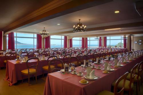 阿瓜尔达Hotel El Molino的大房间设有桌椅和红色桌布