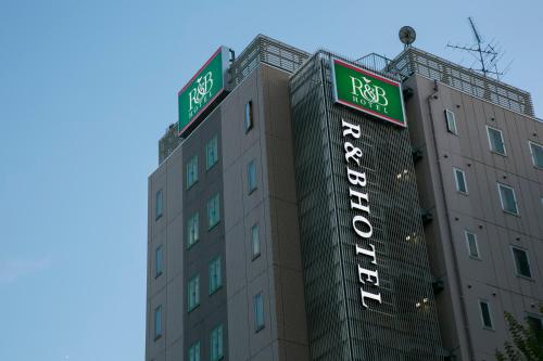 名古屋R&B Hotel Nagoya Nishiki的上面有两条路标的建筑