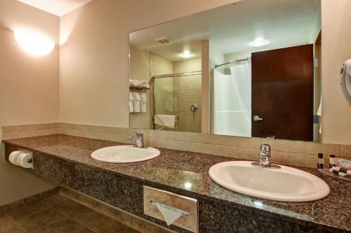 卡姆罗斯卡姆罗斯凯纳塔汽车旅馆的一间带两个盥洗盆和大镜子的浴室