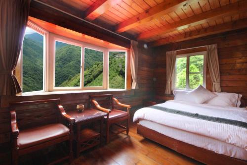Hualing拉拉山5.5K农庄的卧室配有一张床、一张书桌和窗户。