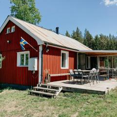 Luxurious red cottage with wood stove near lake