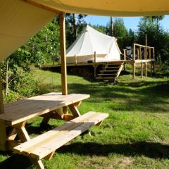 Glamping tent in a forest, lake view