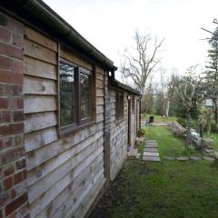 a quirky garden building in an orchard