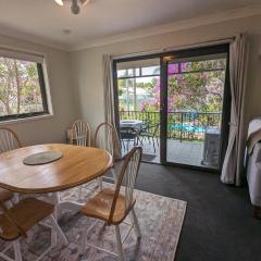 Leafy seaside unit with lagoon style pool and tennis court