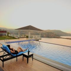 StayVista's The Aquamarine Villa - Igatpuri - Lakeside Retreat with Infinity Pool & Deck, Theatre Room & Gazebo