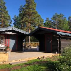 Timber cottages with jacuzzi and sauna near lake Vänern