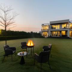 StayVista at Olive Farms with Lawn, Pool, Bonfire & Hill Views