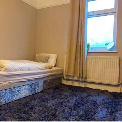 Large room with single bed, work desk and double wardrobe