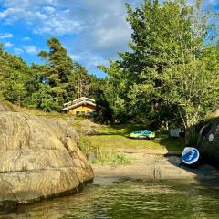 Seaside cabin with boat and beach in Kragerø