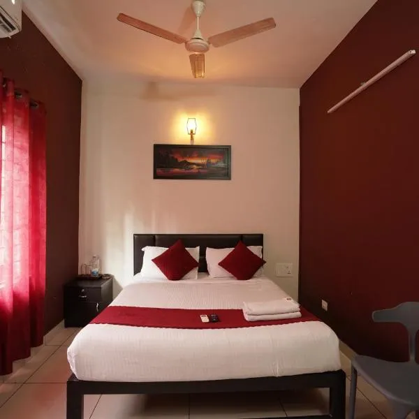 Atmos Inn Calicut Near Aster Mims Hospital，位于科泽科德的酒店