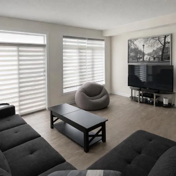 Central & Cozy 2BR Townhome with Free Parking, WiFi, Full Kitchen, Laundry, Steps to Strip Plaza & 5 Min Drive to Innisfil Beach Park! Perfect for Work Trips, Family Travel & Couples!，位于Innisfil的酒店